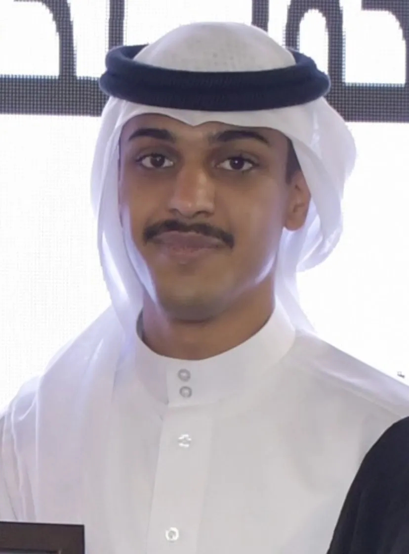 Ali in a white thobe and ghutra at a ceremony