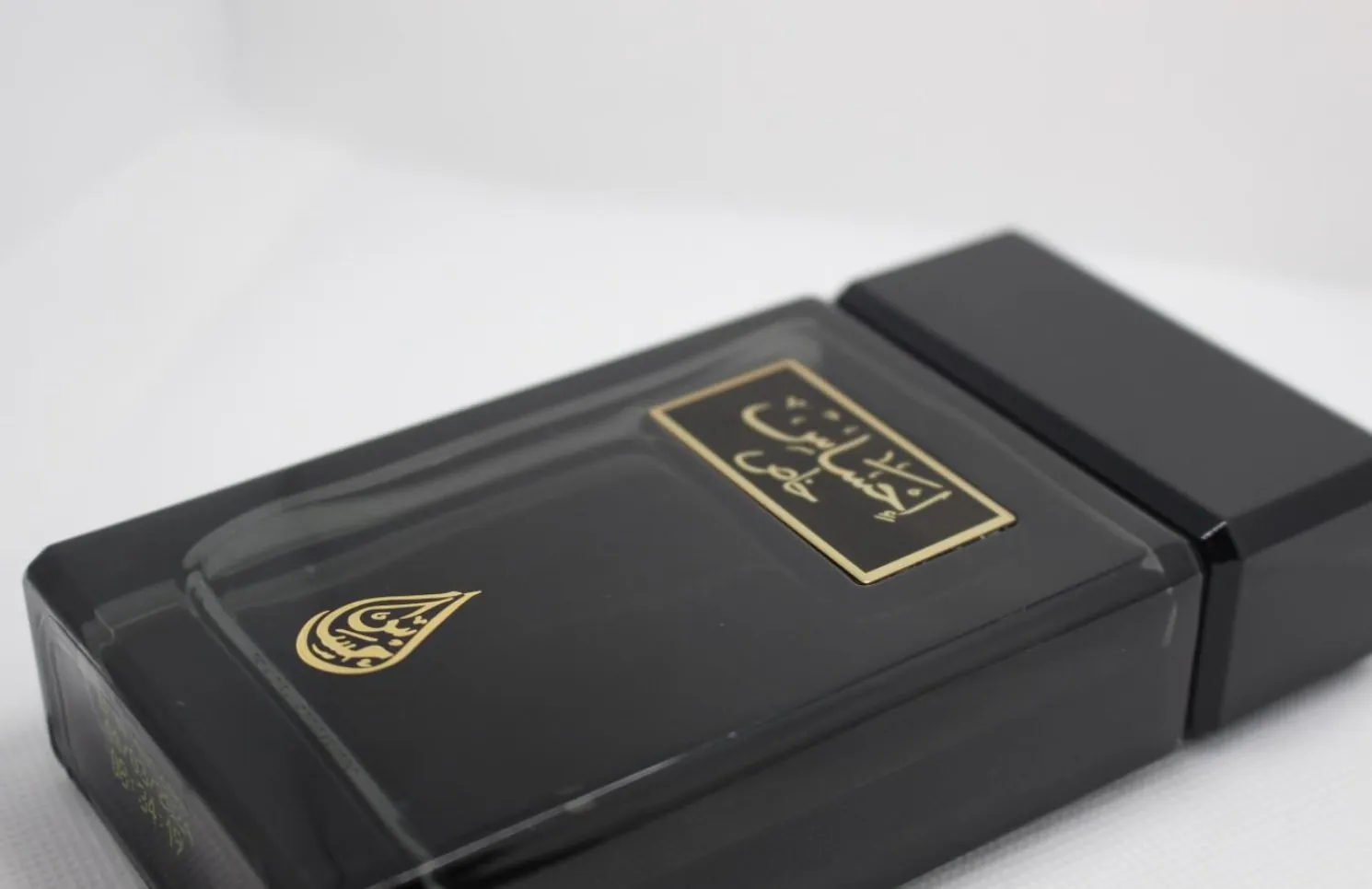 Black perfume box with gold Arabic lettering