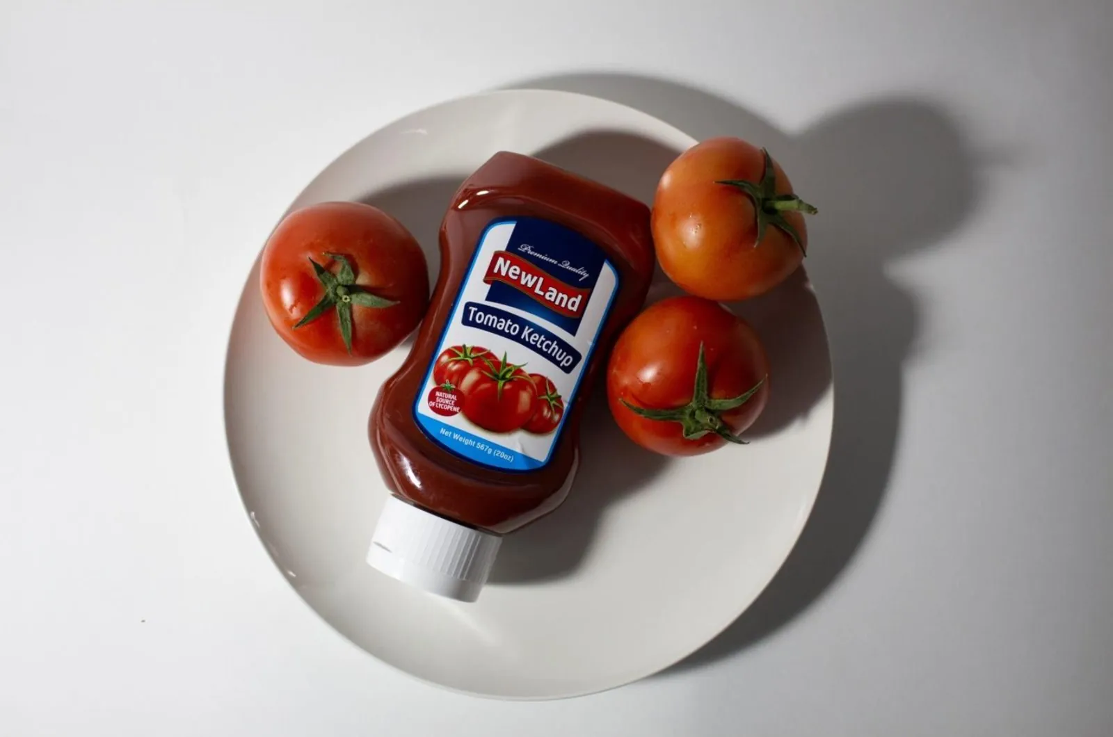 Ketchup bottle on a plate with tomatoes